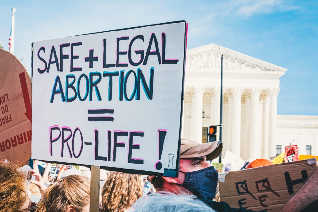 Protest poster saying Safe + Legal Abortion = Pro Life