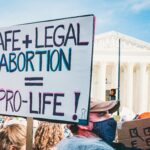 Protest poster saying Safe + Legal Abortion = Pro Life